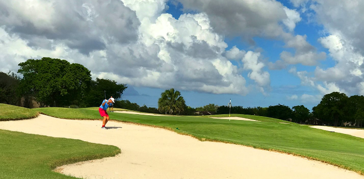 golfer hitting out of a bunker